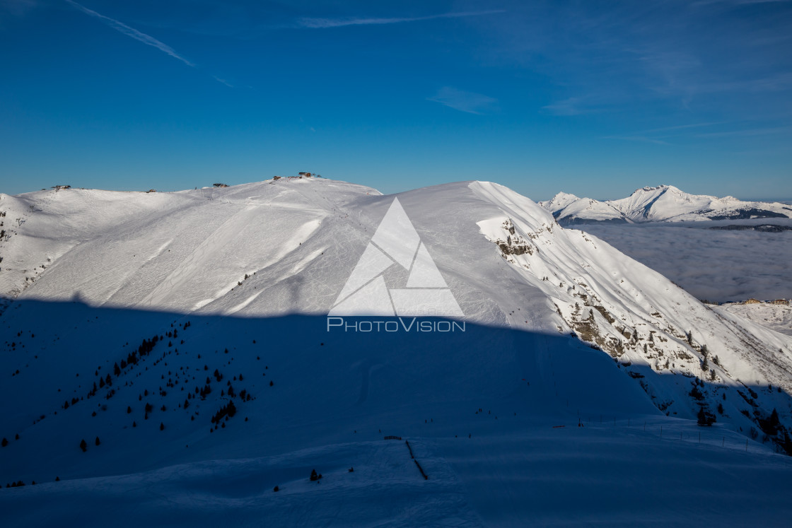 "Inversion in valley and illuminated mountain peaks" stock image