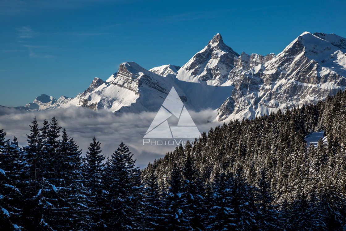 "Inversion in valley and illuminated mountain peaks" stock image