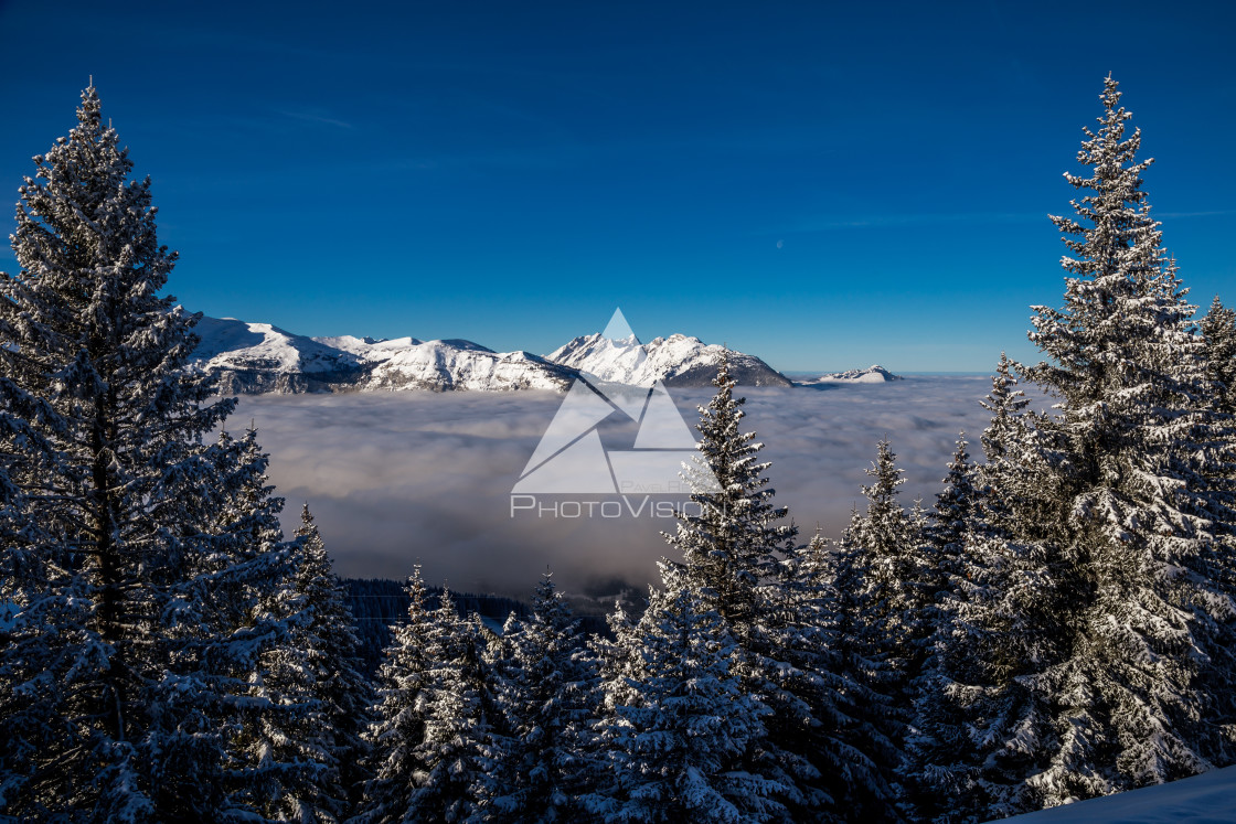 "Inversion in valley and illuminated mountain peaks" stock image