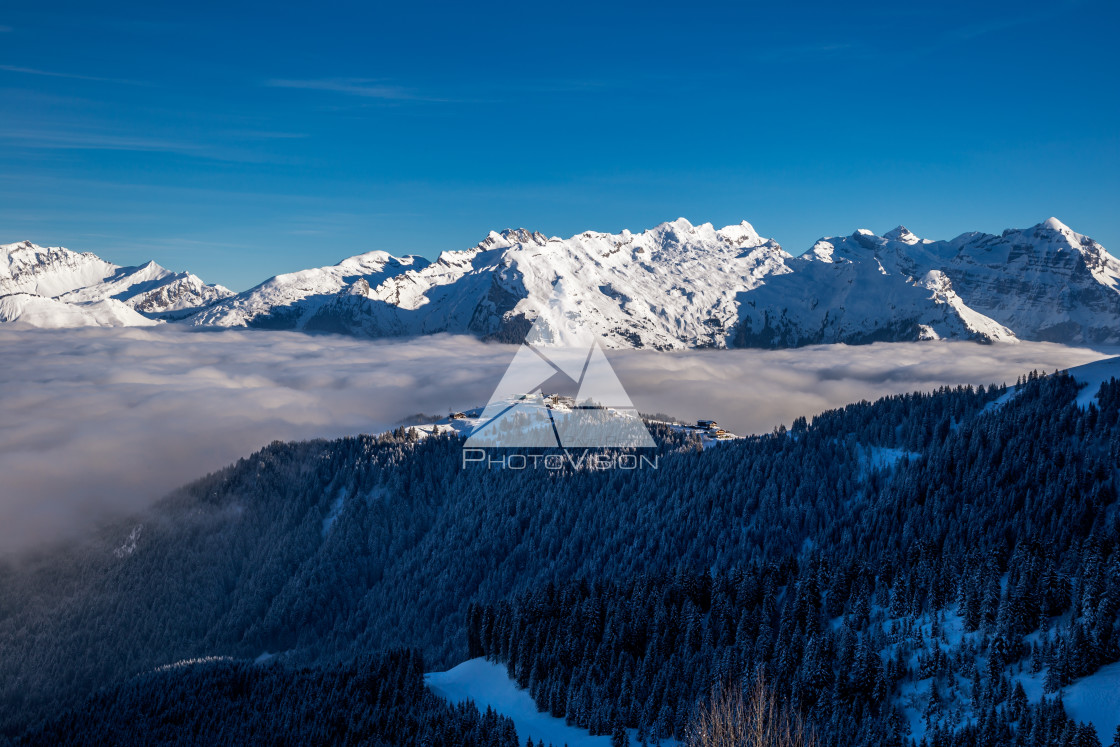 "Inversion in valley and illuminated mountain peaks" stock image