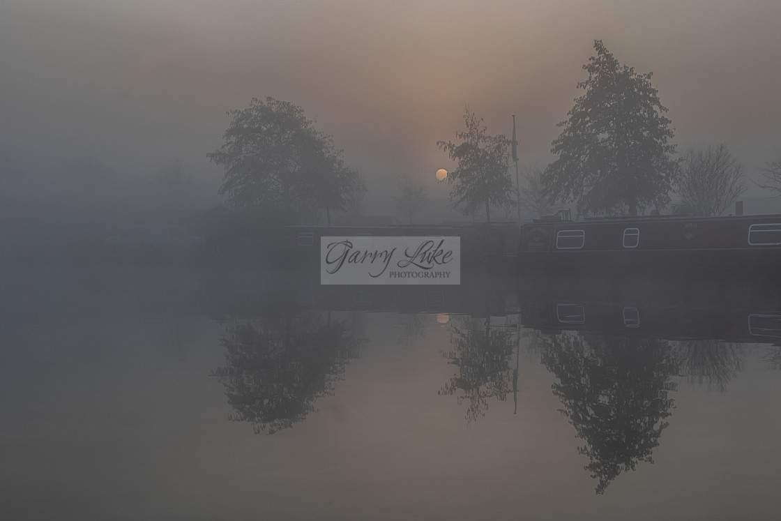 "An eerie misty morning sunrise over the marina" stock image