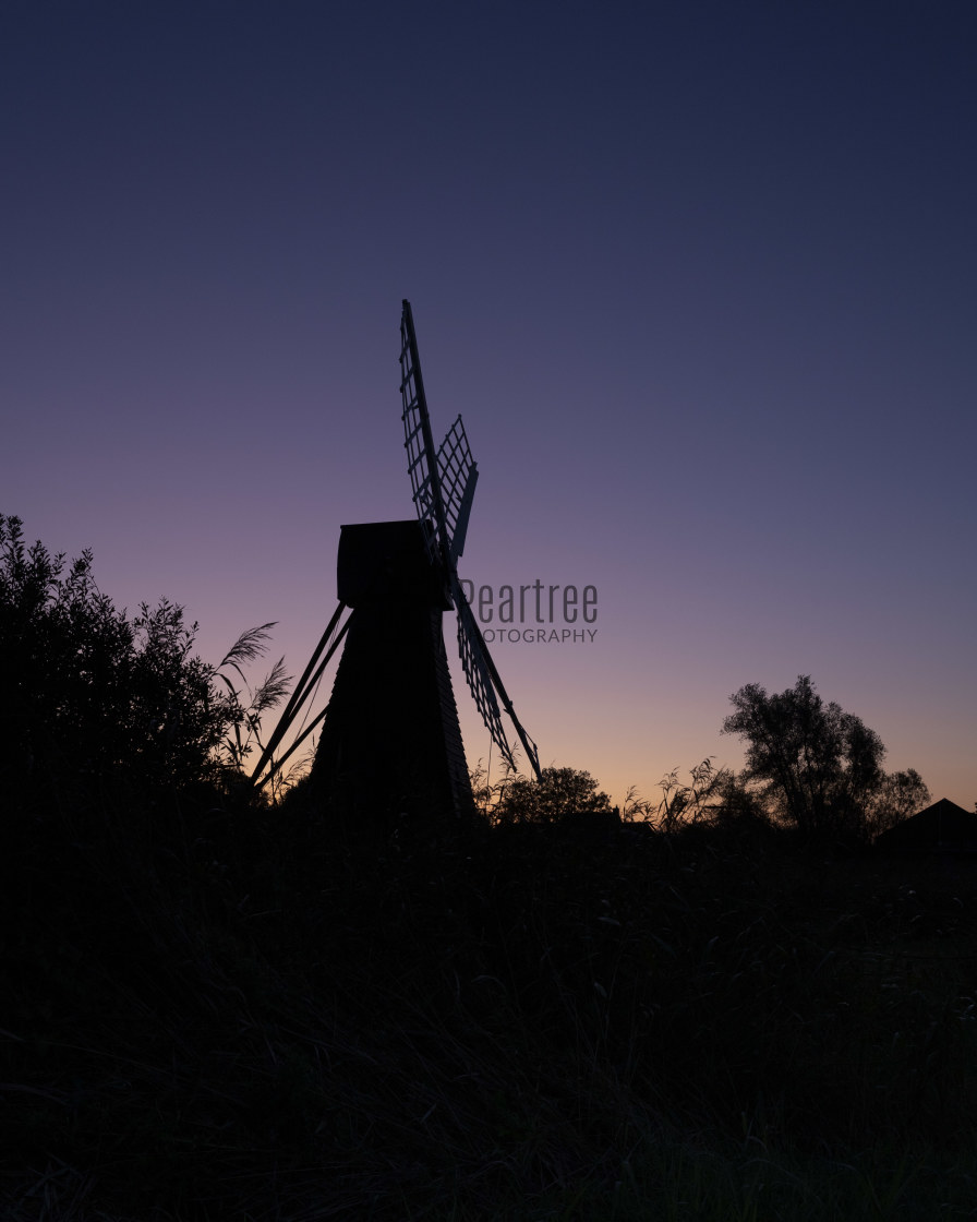 "Sunrise over the Windmill at Wicken Fen" stock image