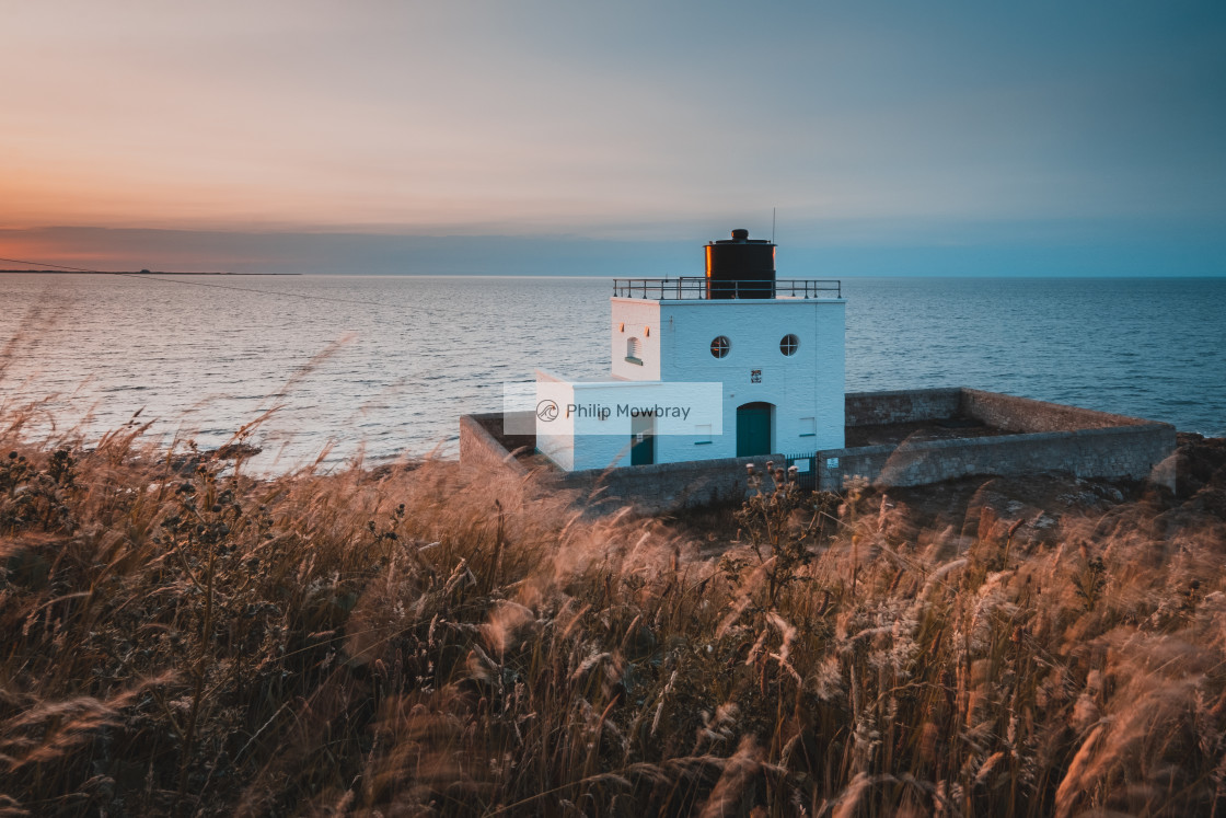 "Orange and Teal Bamburgh Lighthouse, Northumberland" by Philip Mowbray - £12.00 "Orange and Teal Bamburgh Lighthouse, Northumberland" stock image