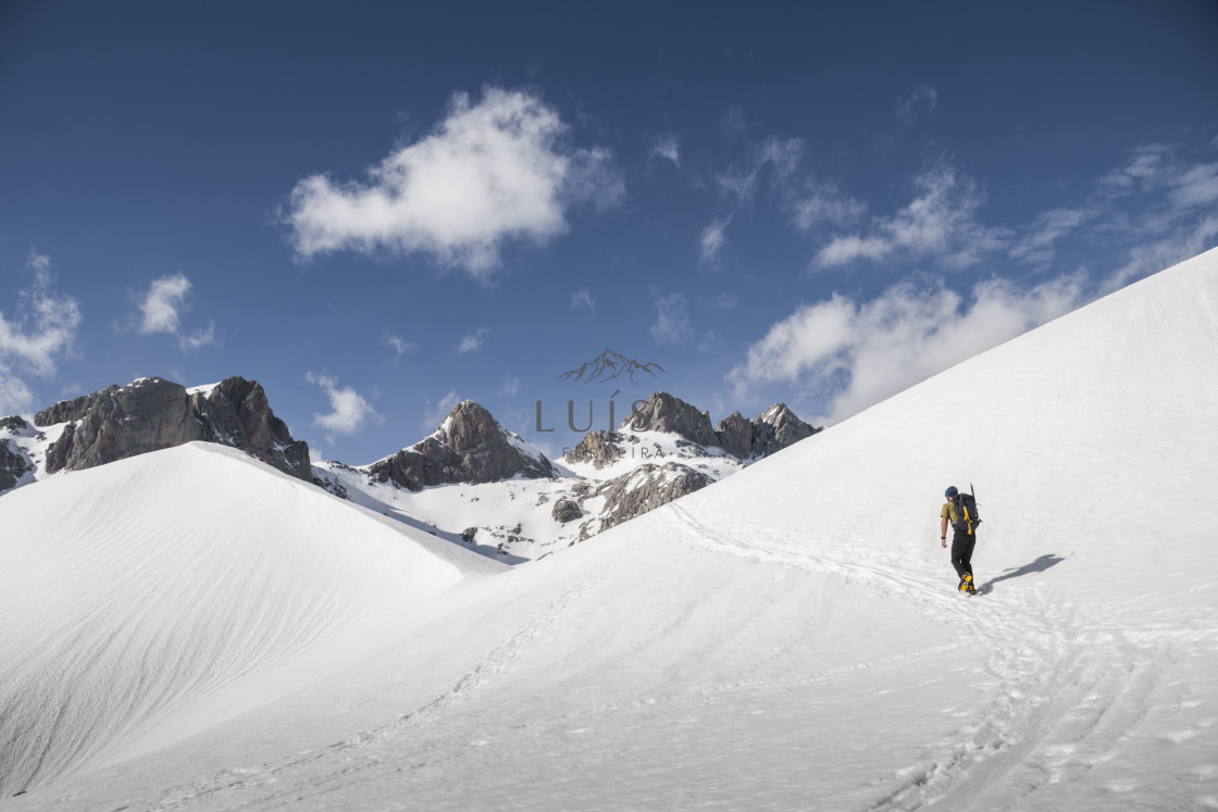 "Hiker walks in the middle of a snow slope" by Luísa Ferreira - $12.29 "Hiker walks in the middle of a snow slope" stock image
