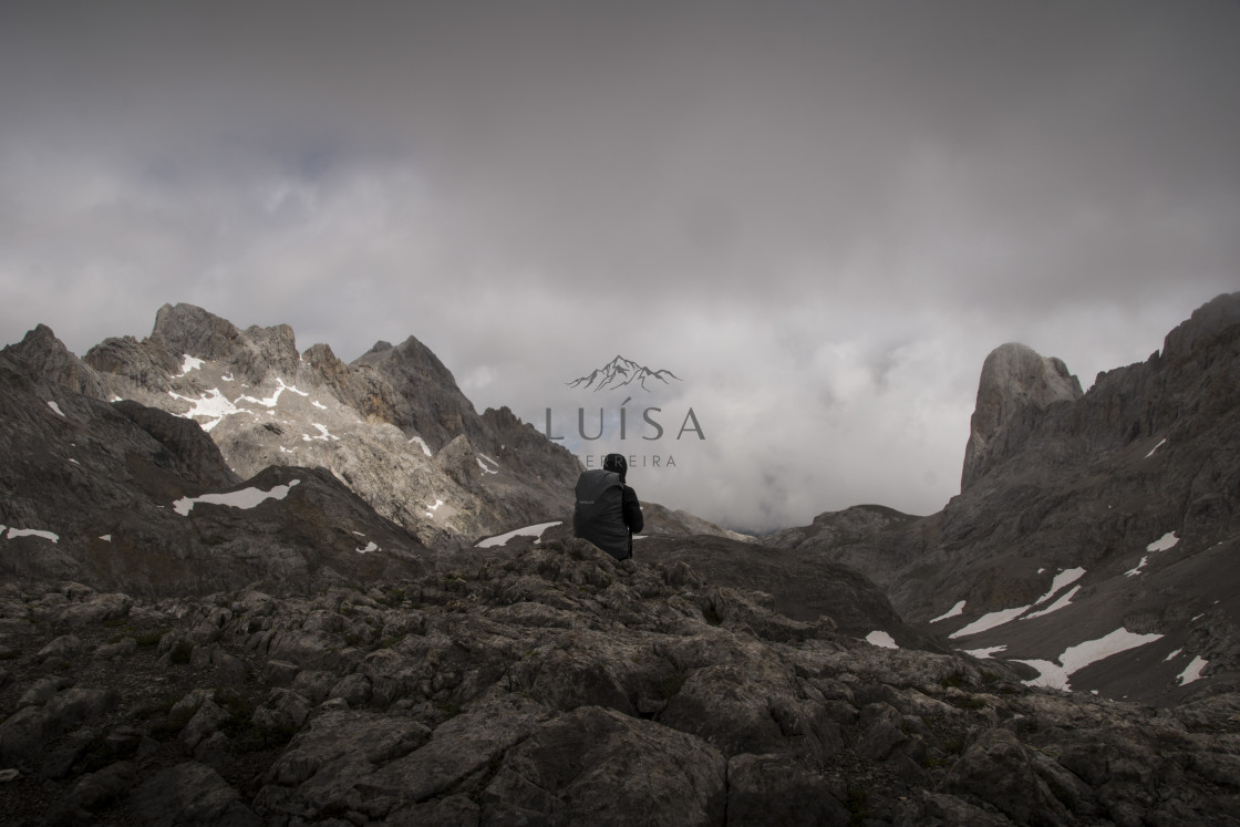 "Trekker stands at the edge of a cliff looking at the outstanding peaks" by Luísa Ferreira - $12.29 "Trekker stands at the edge of a cliff looking at the outstanding peaks" stock image