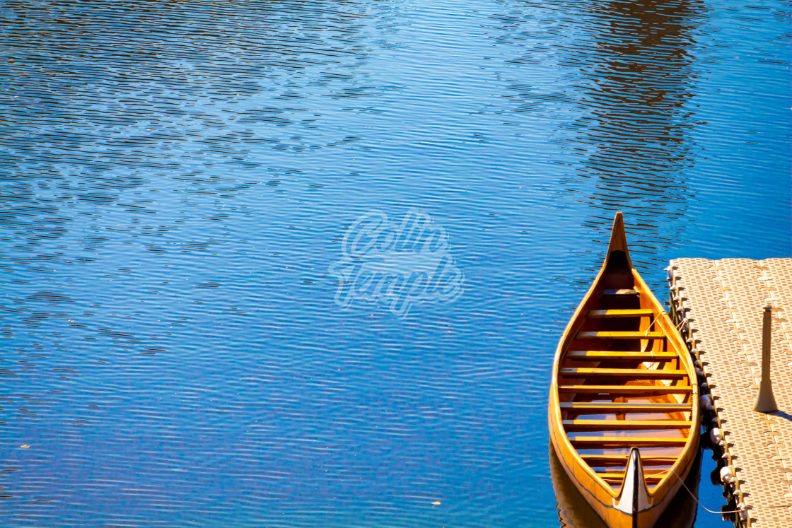 "A Wooden Canoe Docked in a River" by Colin Temple - £4.04 "A Wooden Canoe Docked in a River" stock image