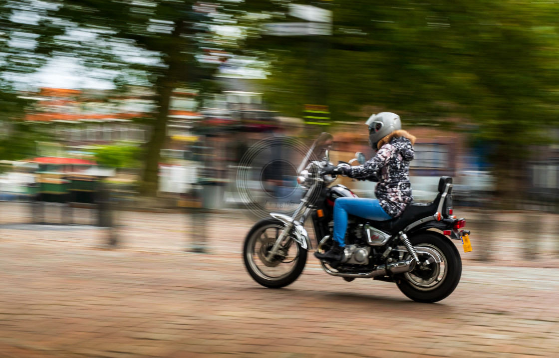 "Biker girl cruising" by Urban Photo Lab - £13.50 "Biker girl cruising" stock image