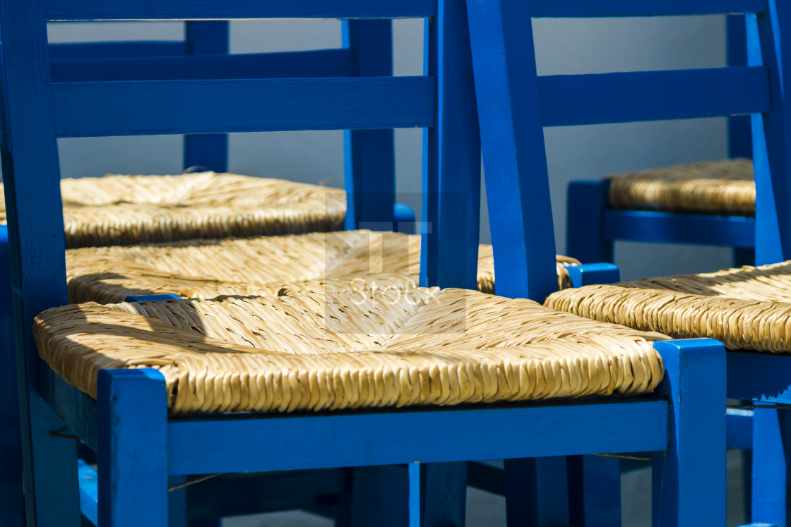 "Blue painted chairs" stock image