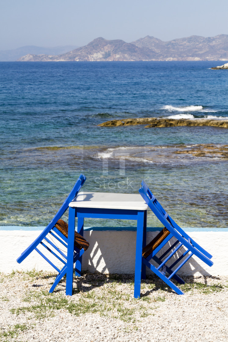 "Painted chairs and table by the sea" stock image