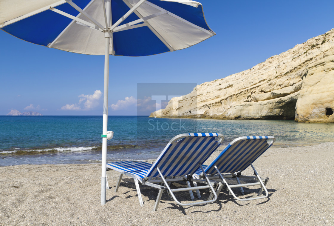 "Two sunbeds and a parasol" stock image