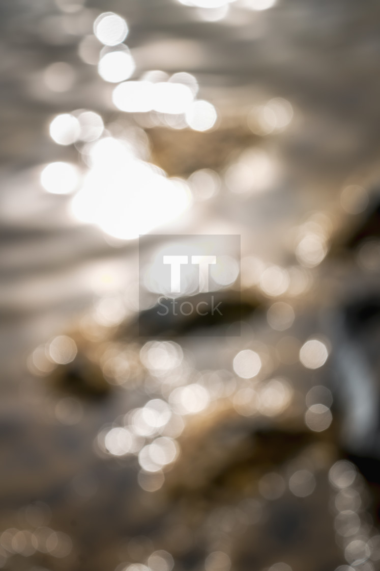 "Bokeh on water surface creating texture background on the coast" stock image