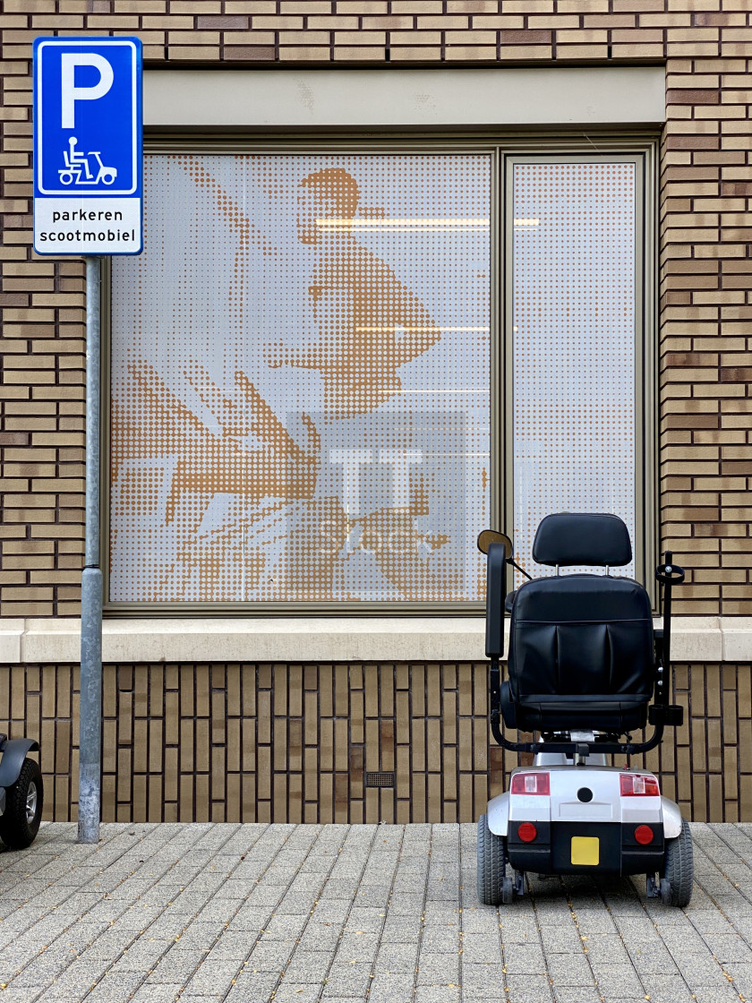 "Physio & parking mobility scooter on the sidewalk outside a medical health clinic." stock image