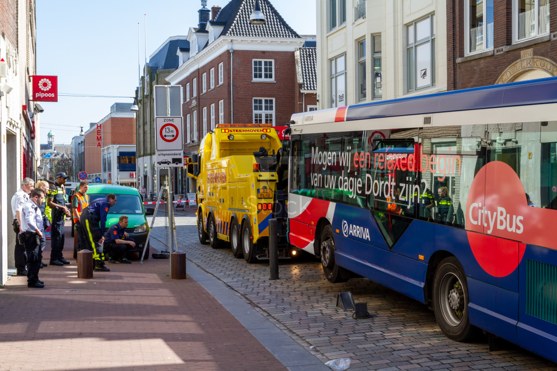 "Public bus stuck on retractable bollards with tow truck" stock image