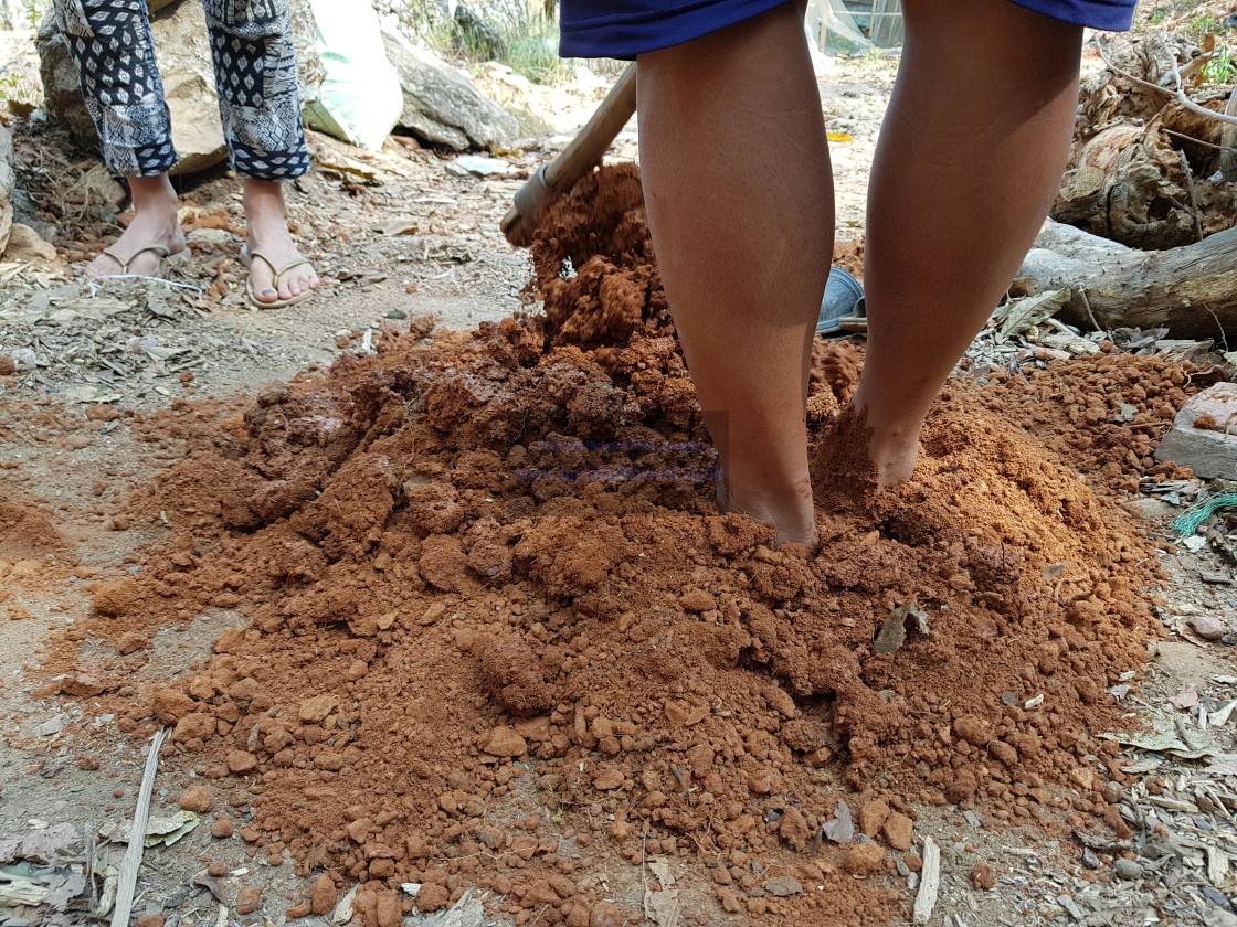 "Mixing Clay with Feet" stock image