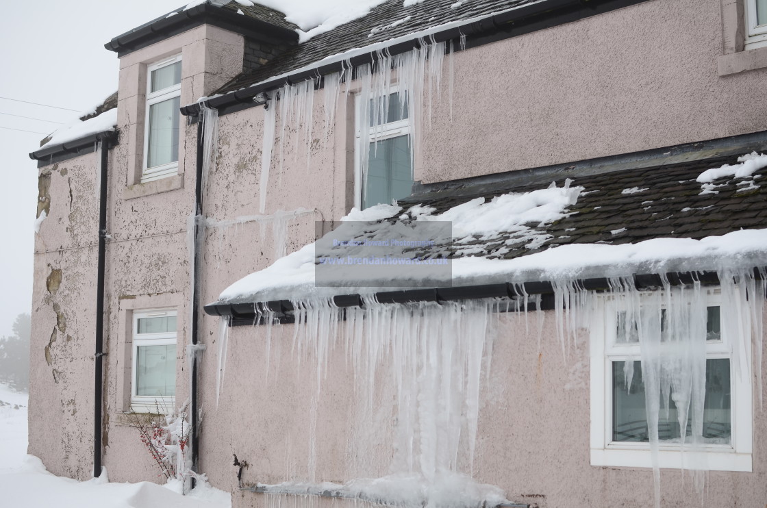 "Large Icicles on House Exterior" stock image