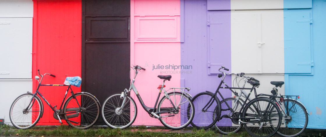 "Four Bikes along a Colorful Wall" stock image