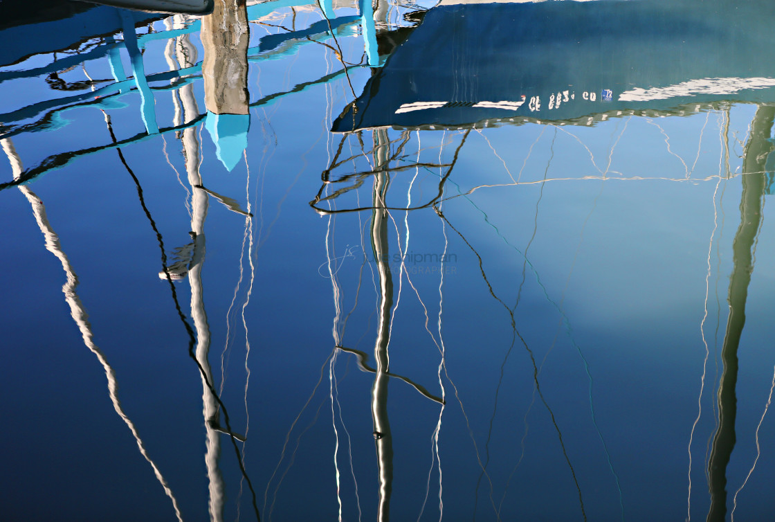 "Reflections of sailboats in the marina." stock image