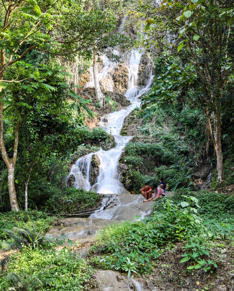 "Enjoying a waterfall in northern Thailand." stock image