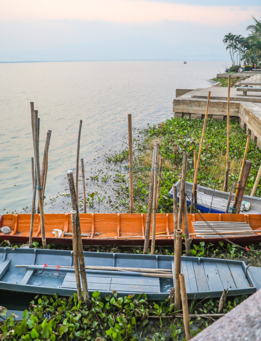 "Two long tail boats tied to the lake dock in northern Thailand." stock image