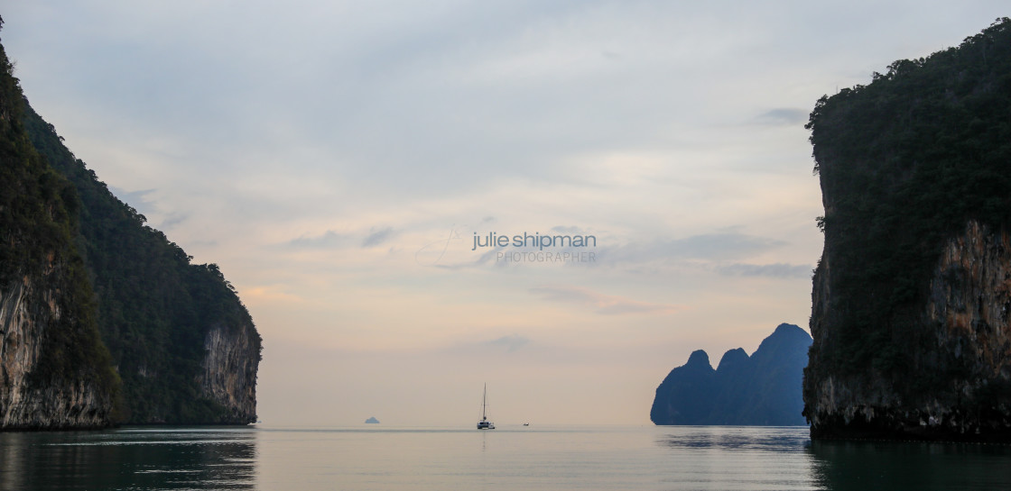 "A catamaran is moored between two Kohs in the islands of Thailand." stock image