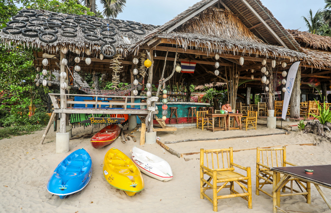 "A colorful beach bar with kayaks in front." stock image