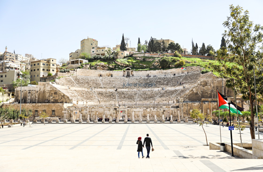 "a couple walks toward the Roman colosseum in Amman." by Julie Shipman - $18.66 "a couple walks toward the Roman colosseum in Amman." stock image