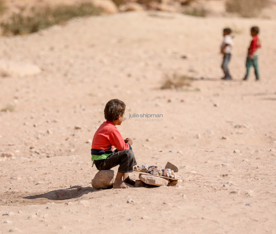 "Young bedouin boy sitting on a rock and selling rocks in Petra." by Julie Shipman - $18.66 "Young bedouin boy sitting on a rock and selling rocks in Petra." stock image