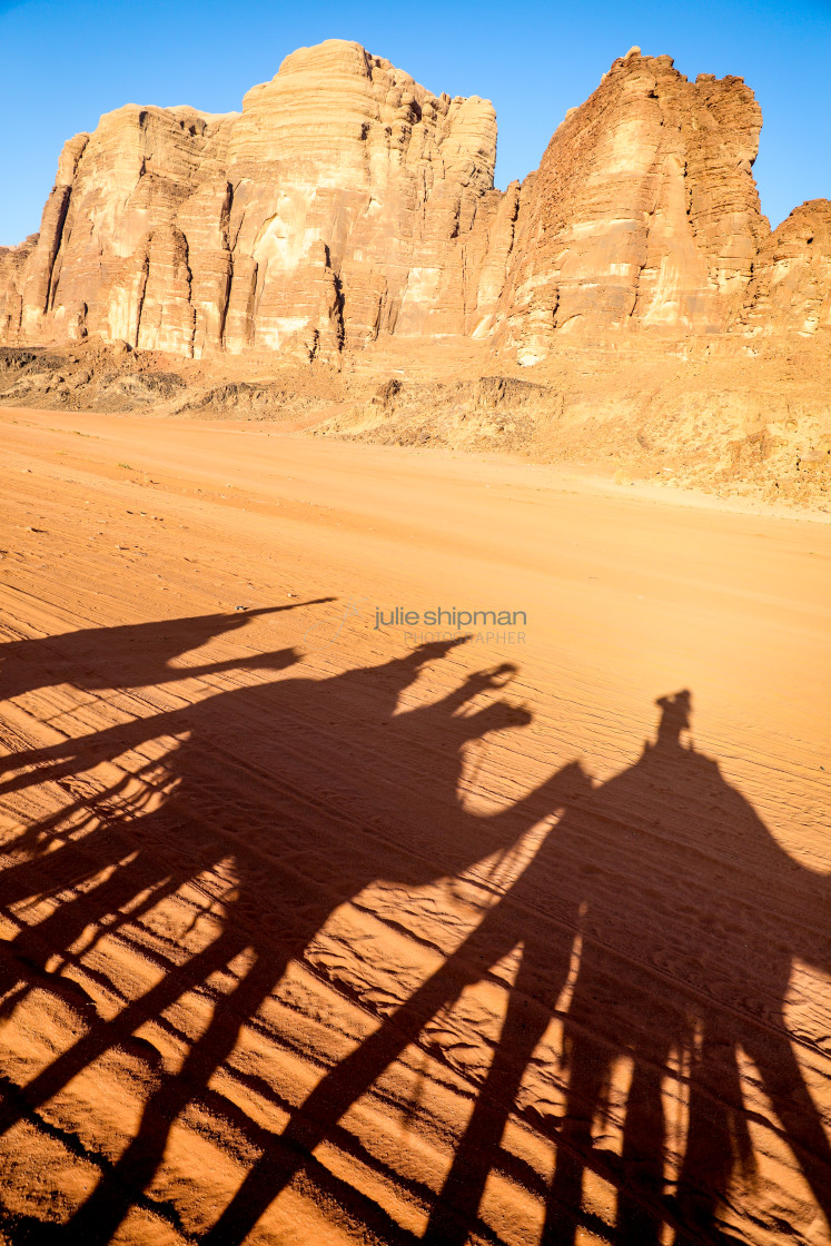 "Shadows of a camel trek; Adventures through Wadi Rum, Jordan." stock image