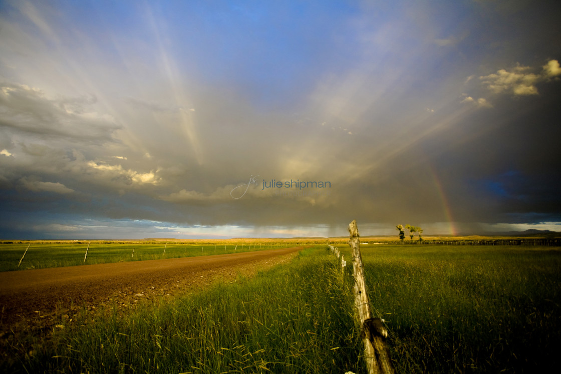 "A rainbow and bright sunrays in Robertson, Wyoming and the ranches in the Bridger Valley." stock image