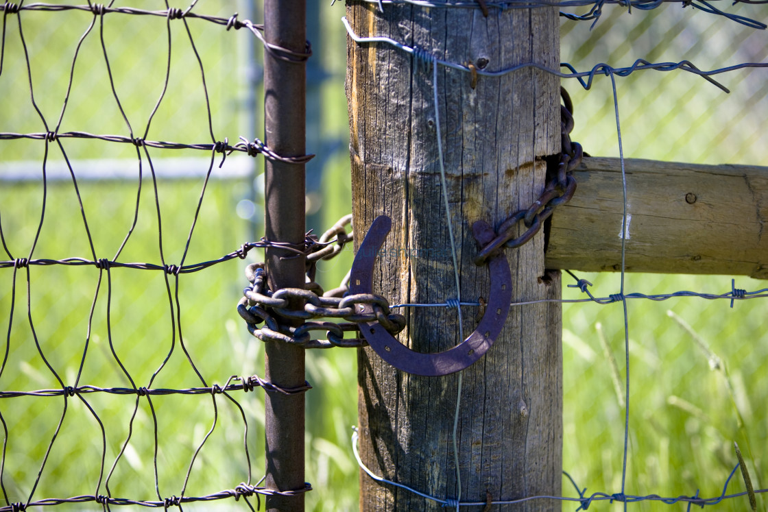 "Horseshoe lock on a barbed wire fence in The West in Robertson, Wyoming and the ranches in the Bridger Valley." stock image