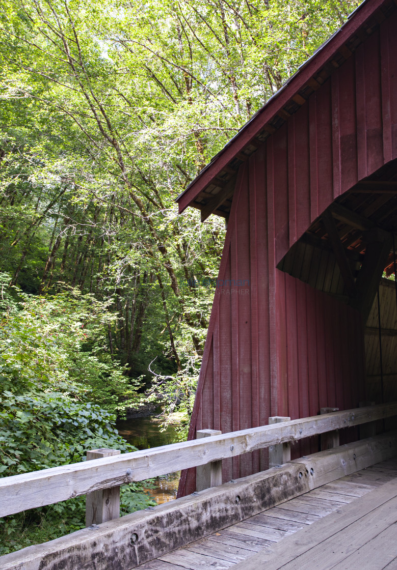 "The old wooden red covered bridge on a road in Oregon." stock image