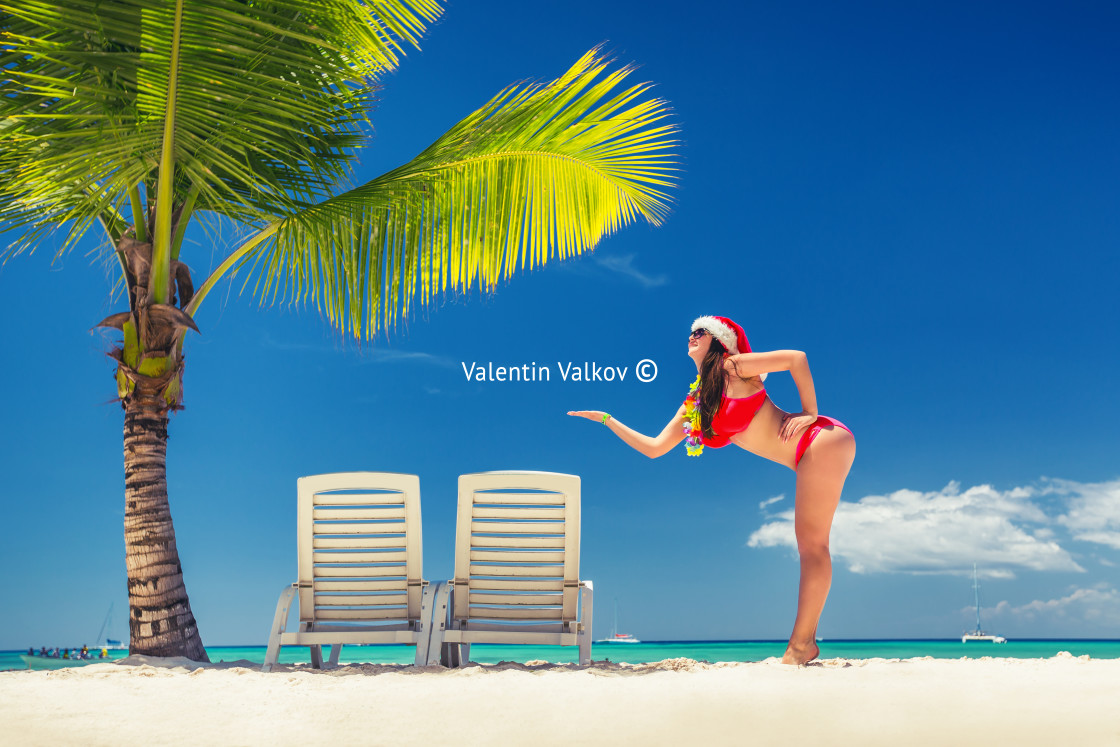 "Happy woman with santa hat on tropical island and exotic beach" stock image