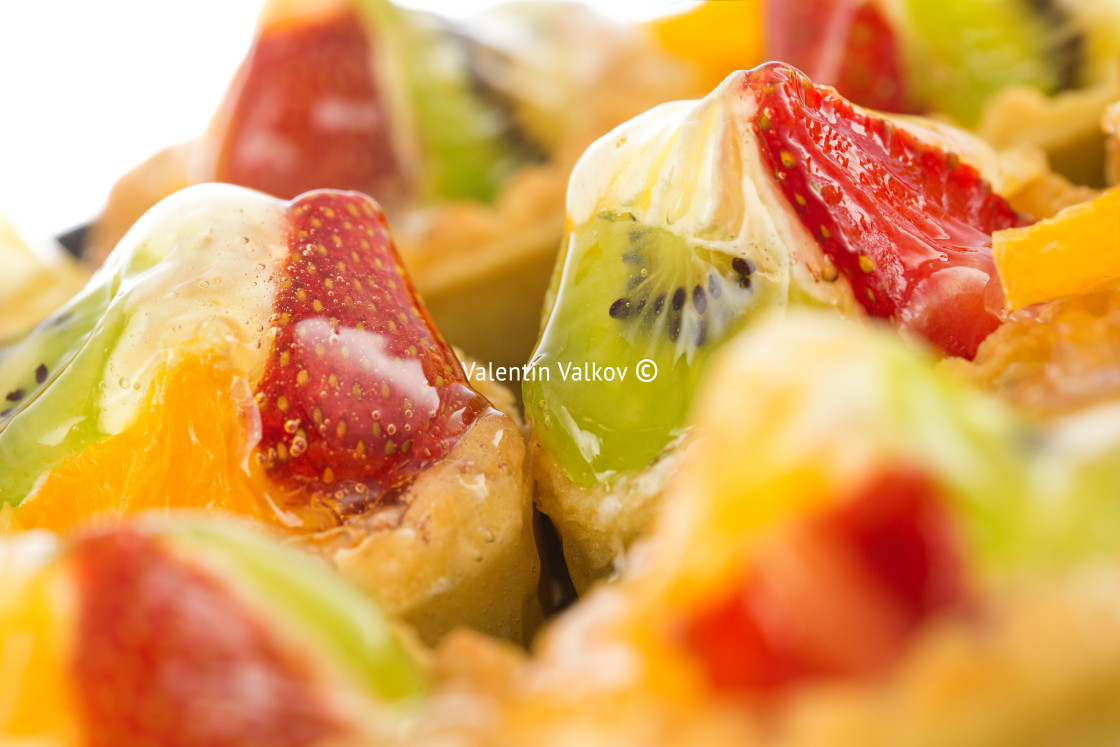 "Group of fruit tartlets on white background. Shallow dof" stock image