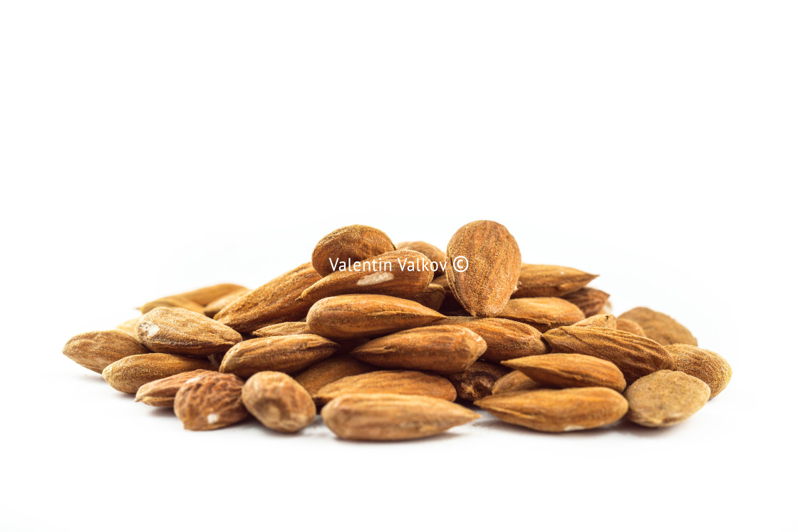 "Almonds in heap over white" stock image