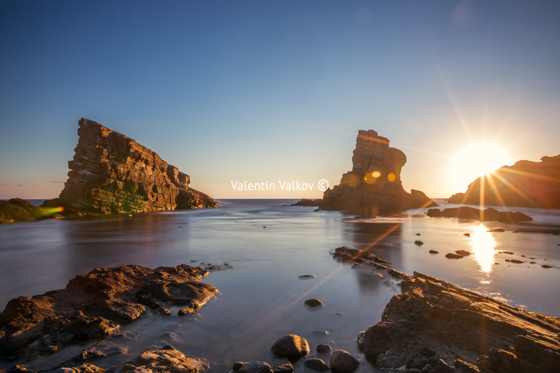 "Dramatic sunrise with mist on the beach with rocks." by Valentin Valkov - $24.56 "Dramatic sunrise with mist on the beach with rocks." stock image