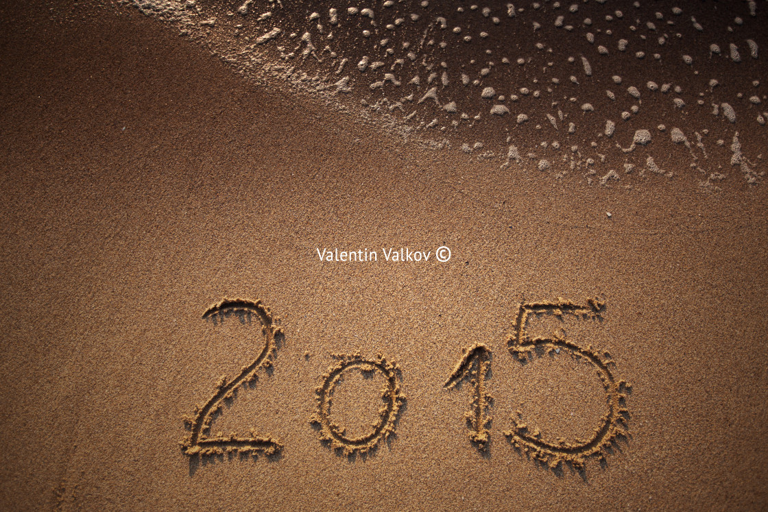 "New year 2015 written in sand" stock image