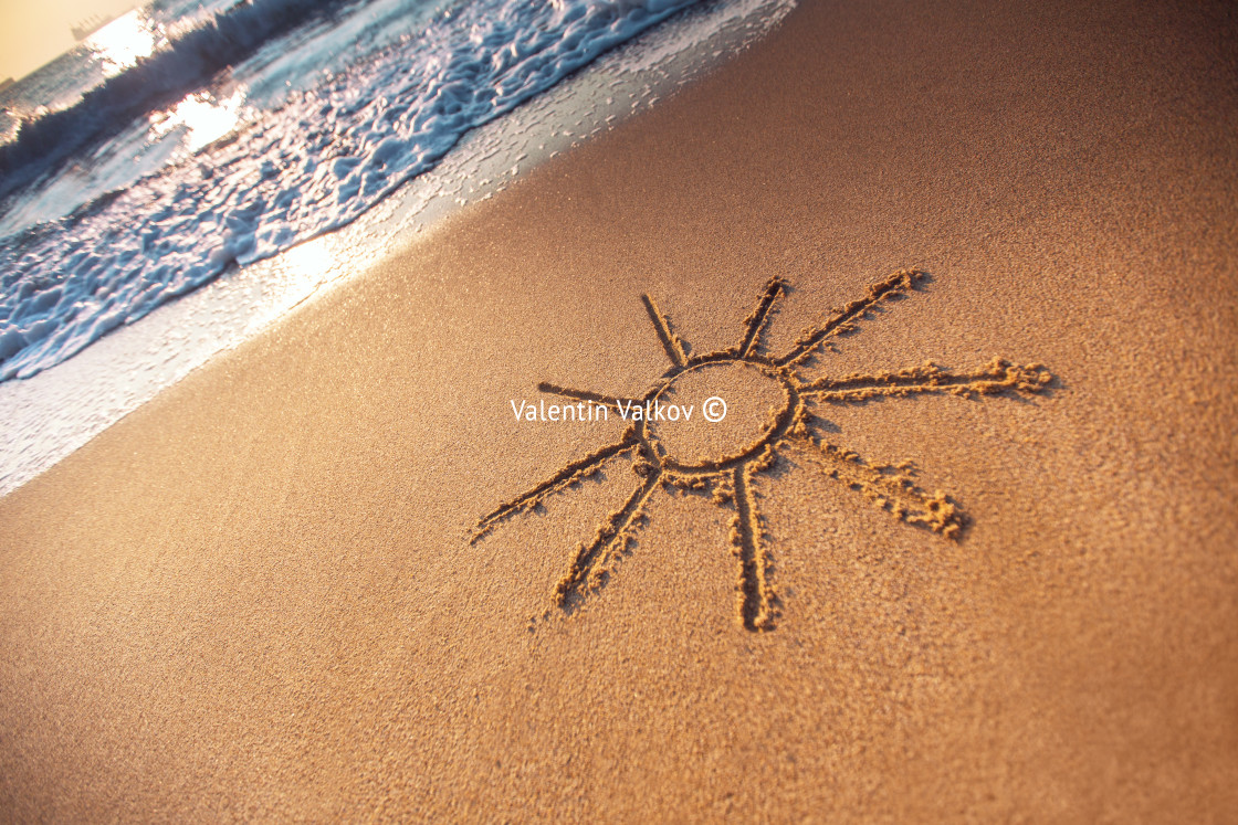 "Simple sun drawing in the sand on the beach" stock image