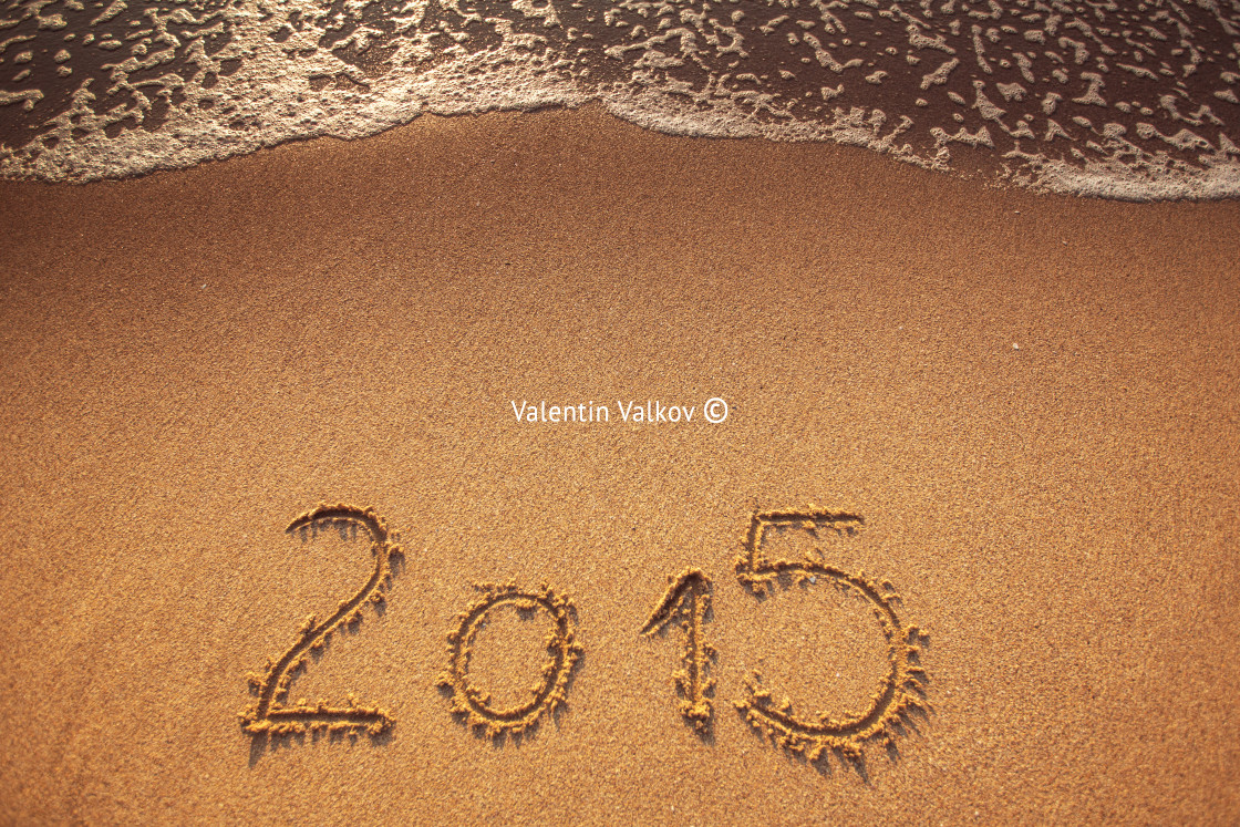 "New year 2015 written in sand" stock image