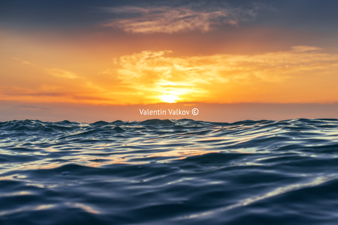 "Sunrise and shining waves in ocean" stock image