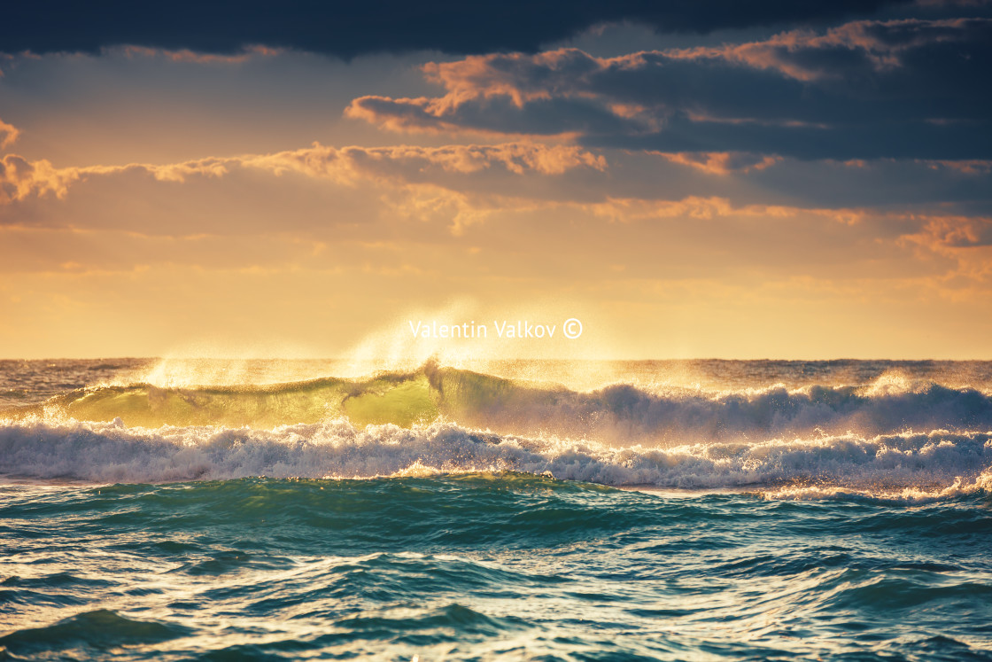 "Sunrise and shining waves in ocean" stock image