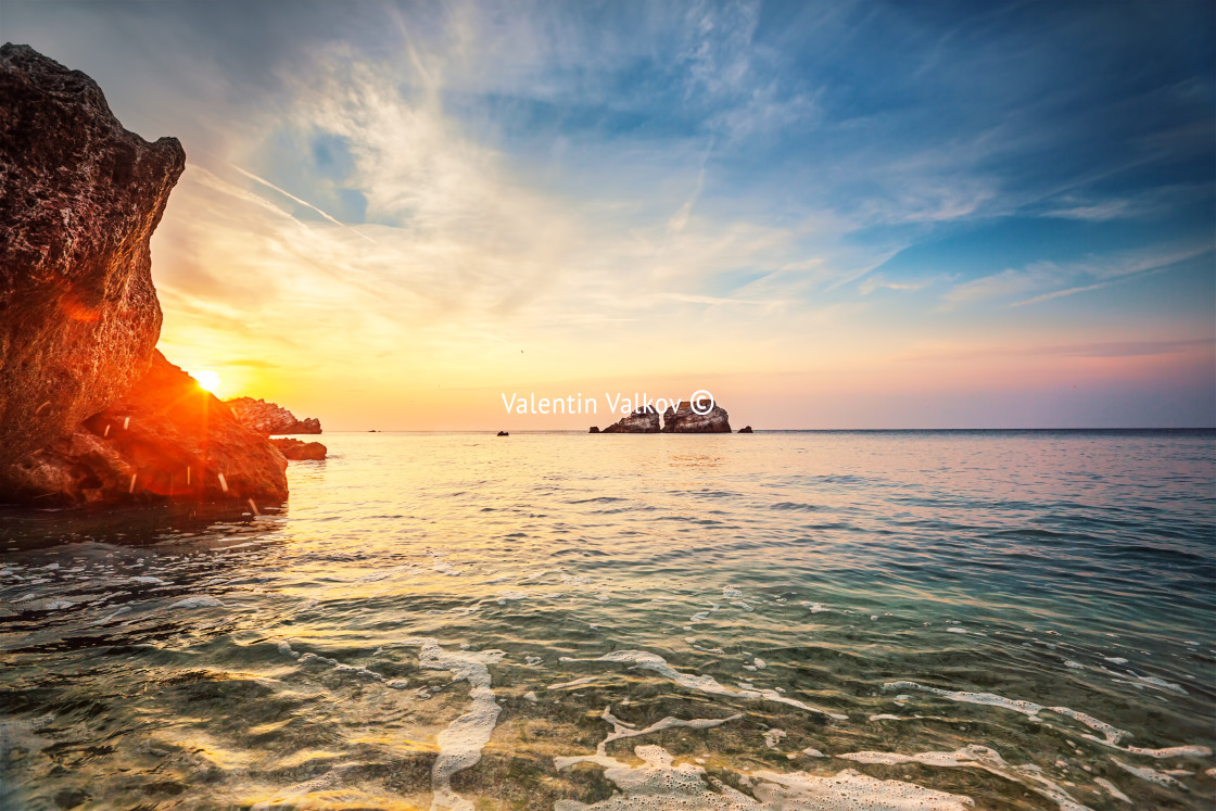 "Tropical colorful sunset at the stones beach." stock image