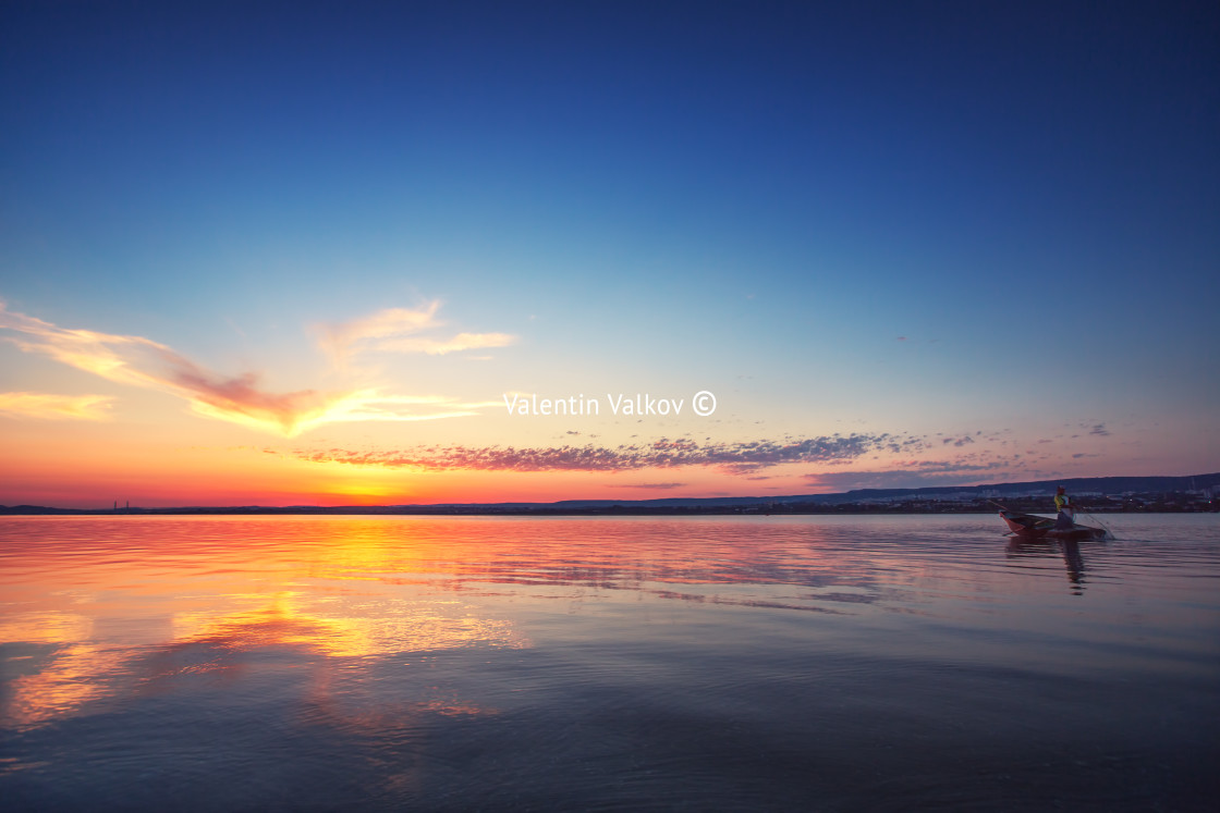 "Sunset Over the lake and silhouette of fishermen" stock image