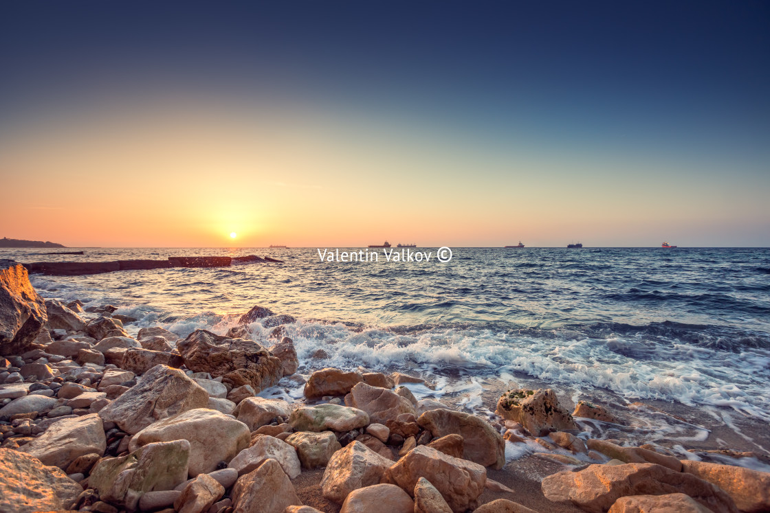 "Tropical colorful sunrise at the stones beach." stock image