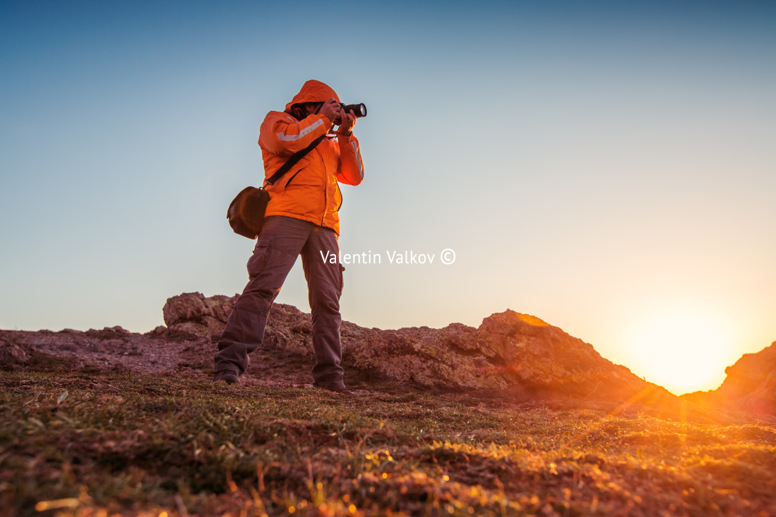 "Nature photographer taking photos in the mountains" stock image