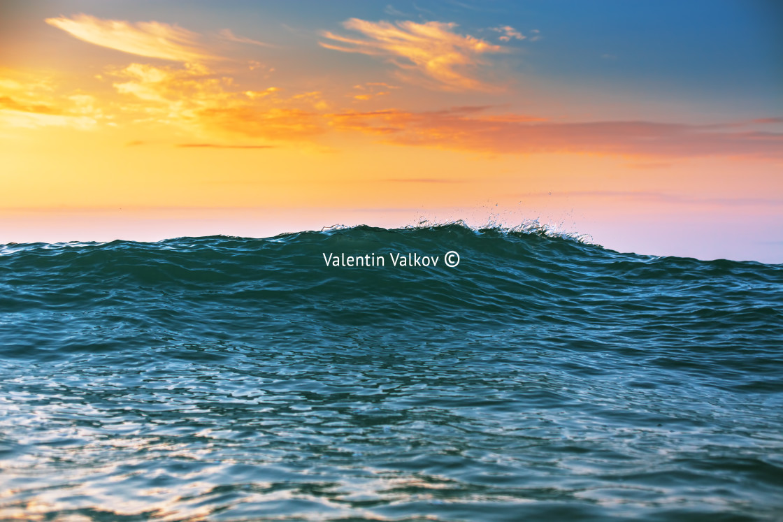 "Sunrise light shining on ocean wave" stock image