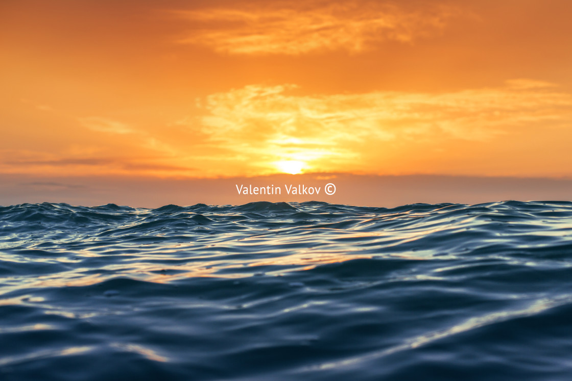 "Sunrise and shining waves in ocean" stock image