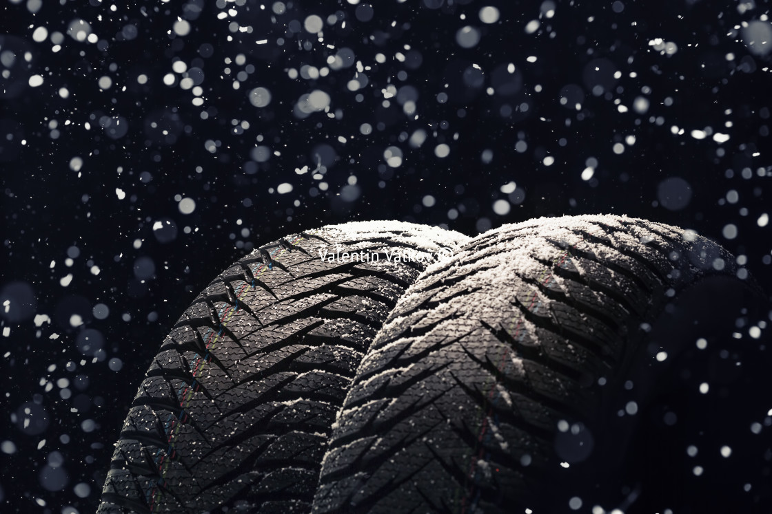 "Winter Car tires with snow on black" stock image