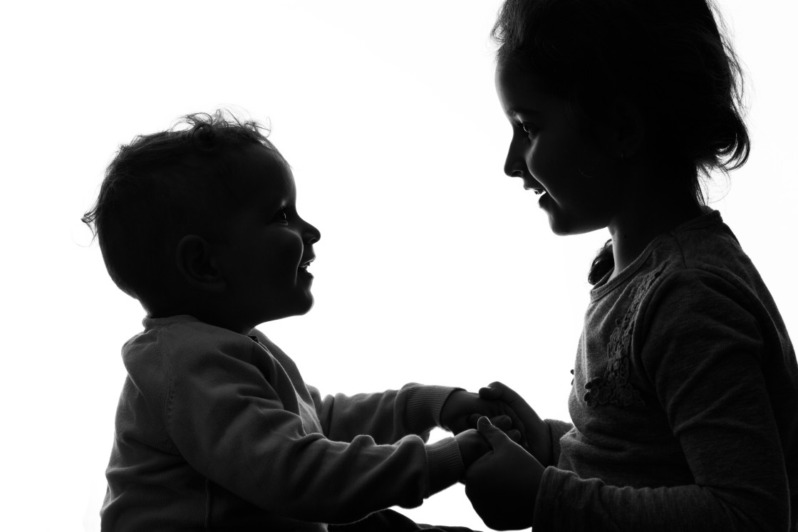 "Baby boy and girl silhouette over white background." stock image