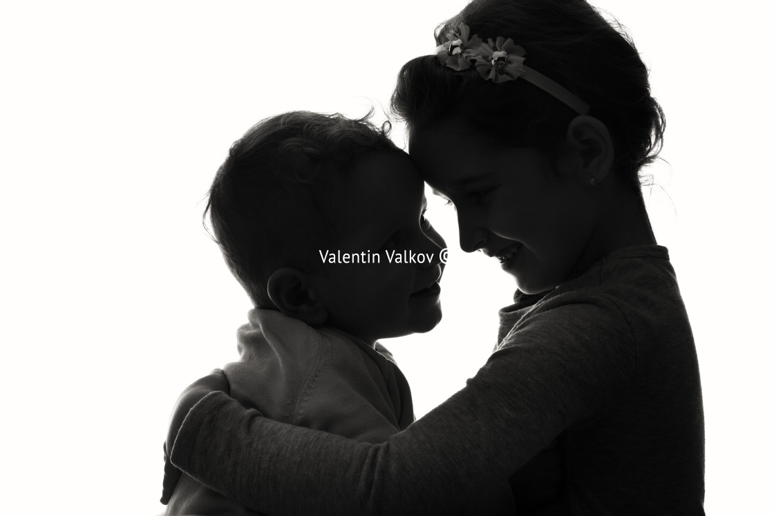 "Baby boy and girl silhouette over white background." stock image