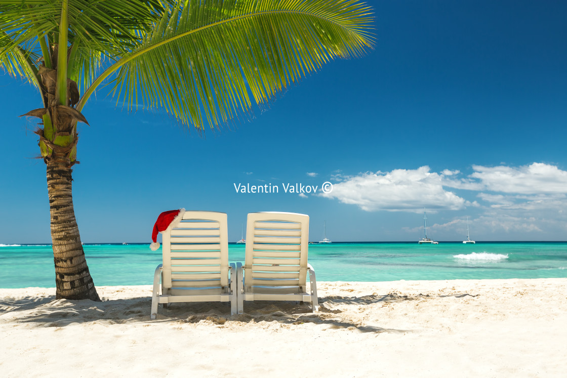 "Santa's hat and sun loungers on the tropical beach" stock image